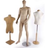 A composition male mannequin with detachable limbs on a metal stand;   together with a  clear