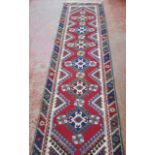 A Middle Eastern design wool  runner   with six ghuls 290cm x 73cm.