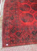 An Afghan Carpet,   three rows of elephant feet on a red ground.300cm x 226cm