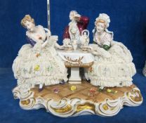 A German porcelain figure group  , drinking tea, marked Unter Weiss Bach to base, 31cm wide approx.