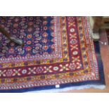 A Middle Eastern style carpet   with a geometric central panel on a blue ground.320cm x 200cm