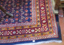 A Middle Eastern style carpet   with a geometric central panel on a blue ground.320cm x 200cm