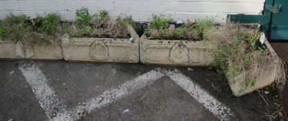 A group of eight stonecast curb flower troughs.