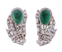 A pair of emerald and diamond ear clips, the pear shaped emerald within a...  A pair of emerald