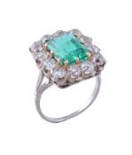 An emerald and diamond ring, the central rectangular shaped emerald  An emerald and diamond