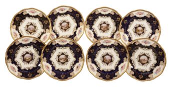Eight Coalport porcelain dessert plates  , circa 1900, each decorated with a central landscape
