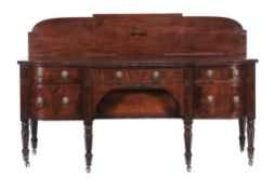 A George IV mahogany sideboard  , circa 1825, of breakfront bow outline, the top with reeded edge