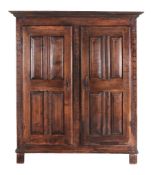 A Louis XV carved walnut armoire  , circa 1750 and later, with moulded cornice above a pair of