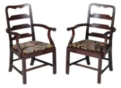 A pair of mahogany armchairs in George II style,   late 19th/early 20th century, together with two