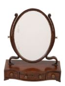 A George III mahogany serpentine fronted dressing mirror  , circa 1770, the oval plate flanked by