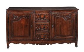 A Louis XV oak cupboard  , with a central bank of three drawers, backed on either side by a