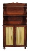 A George IV mahogany bookcase  , circa 1825, the upper waterfall section with two open shelves, the