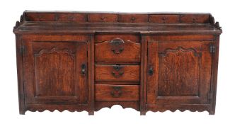 An oak dresser base,   second half 18th century, probably West Country, the plank top with an