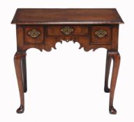A walnut side table  , circa 1735 and later, the rectangular quarter veneered top above three