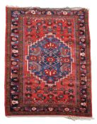A Hamadan rug  , the brick red field with stepped blue medallion woven with stylised birds and