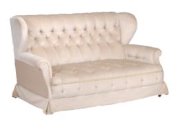 A matched pair of late Victorian sofas,   circa 1900, with wing and scroll arms, buttoned back and
