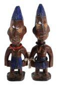 A pair of carved and painted wood models of the  Ibeji   twins,   Yoruba, Nigeria, late 19th