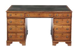 An oak pedestal partner's desk  , 19th century, the gilt tooled leather inset top above three short