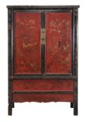 A Chinese red and black lacquer cupboard,   19th century, the pair of red lacquer doors decorated