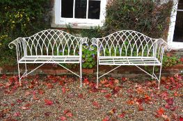 A pair of white painted metal garden seats,   loosely in the George III style, late 20th century,