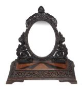 An Anglo Indian carved hardwood, birds eye maple and rosewood dressing mirror,   circa 1860,