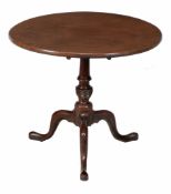 A George III mahogany tripod table  , circa 1770, the circular top above a turned pillar with