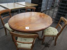 Dark wood oval pedestal table with four wood framed upholstered chairs