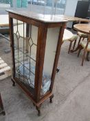 Dark wood display cabinet with glass doors