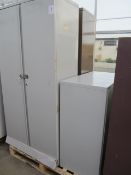 Two steel two door stationary cupboards and one low level storage cupboard