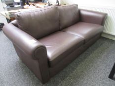 Two seater brown leatherette upholstered sofa. Located at Unit 1, Neptune Court, Barton Manor,