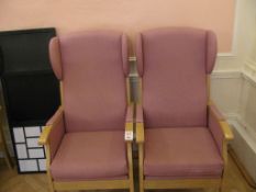 Two pink upholstered wingback arm chairs