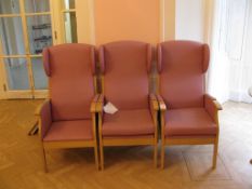 Three pink upholstered wingback arm chairs