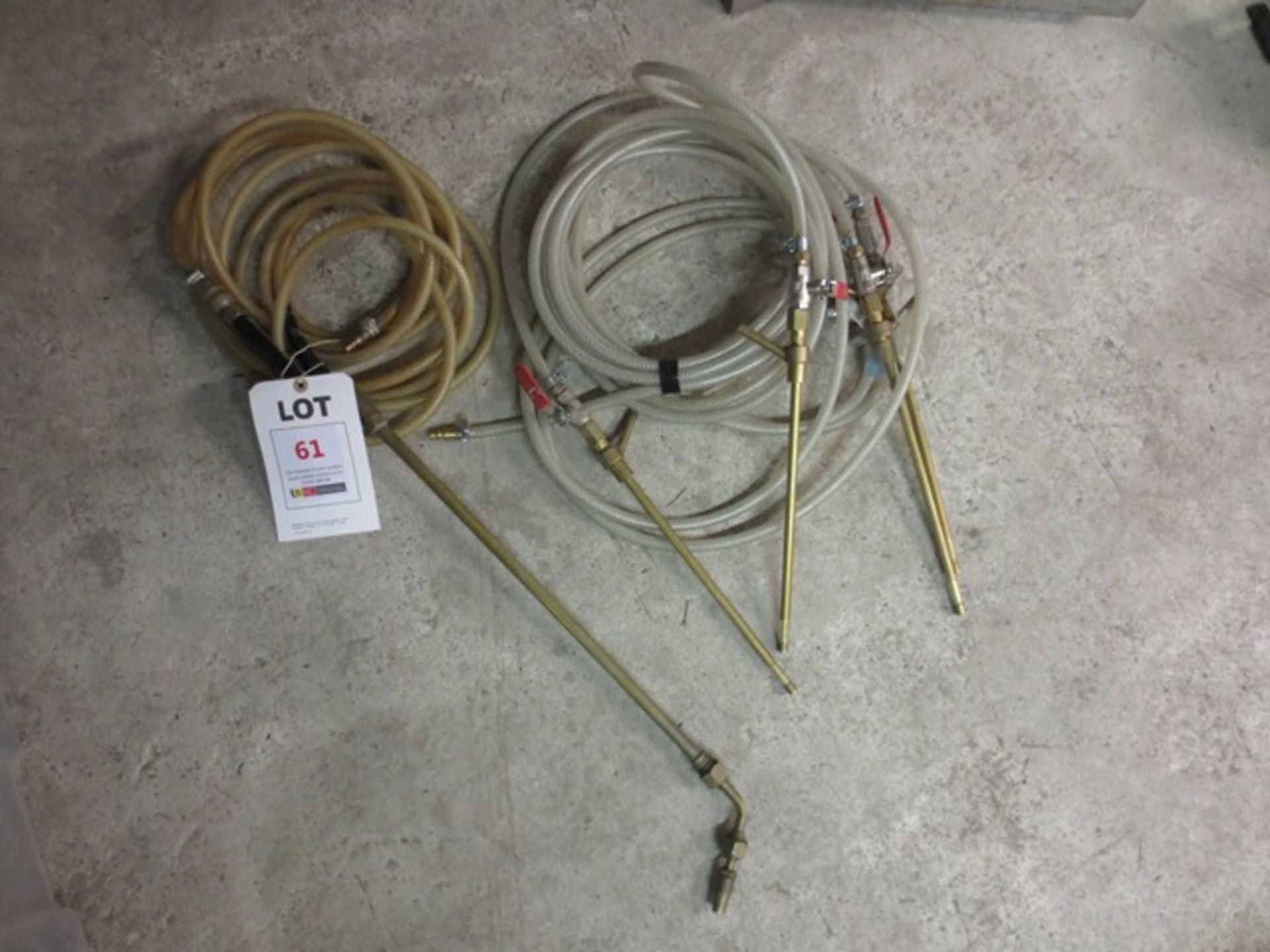 Five assorted gas torches and hose reels