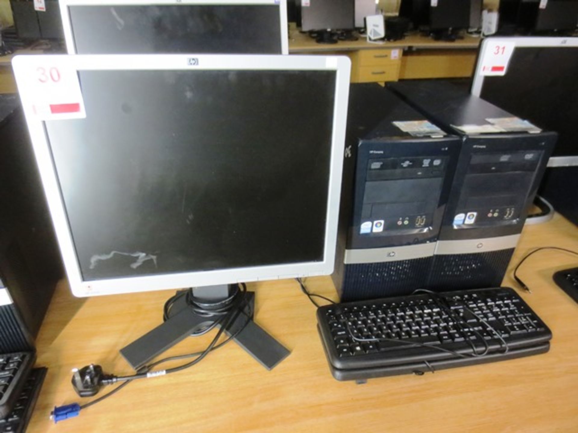 Two HP Compaq DX2400 micro towers, serial nos: 2UA84503P6, ZUA844OU9D, two flat screen monitors,