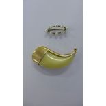 A 9ct gold mounted tiger's tooth brooch together with an oval pearl set 9ct gold brooch (2)