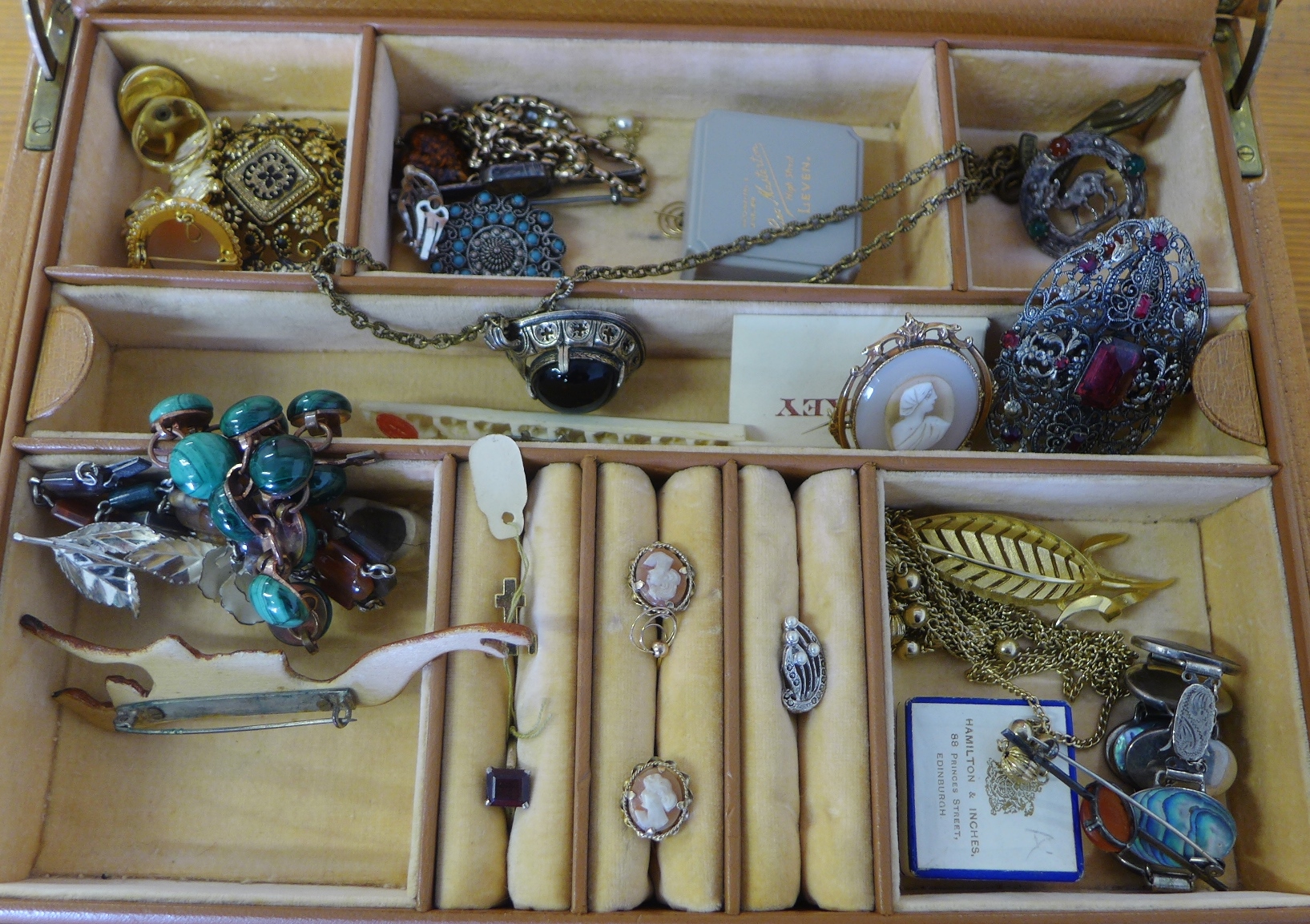 A leather jewellery box containing a large quantity of vintage costume jewellery