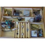 A leather jewellery box containing a large quantity of vintage costume jewellery