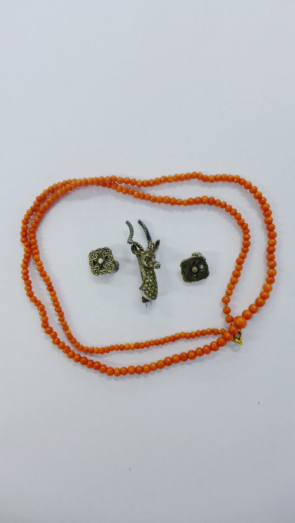 A pair of Iona silver cross earrings together with a silver and marcasite stag’s head brooch and a