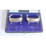A pair of Birmingham silver salts with blue glass liners by Walker and Hall in fitted case