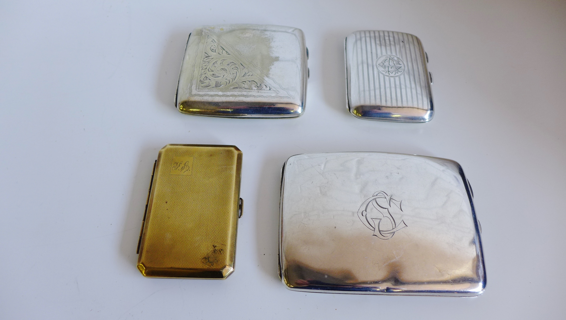 Two silver cigarette cases and two plated cigarette cases (4)