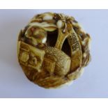 A Japanese ivory netsuke, the small circular pebble intricately carved with many hares having