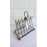 A silver plate seven bar toast rack in the form of crossed golf clubs, 18cm high