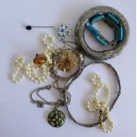 A collection of costume jewellery to include an amber dress ring, faux pearl beads and white metal