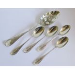 A mixed lot of silver to include a berry spoon, two napkin rings and four teaspoons (7)