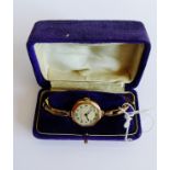 Lady's 9 carat gold cased wristwatch, the octagonal enamel dial with Arabic numerals and retailer'