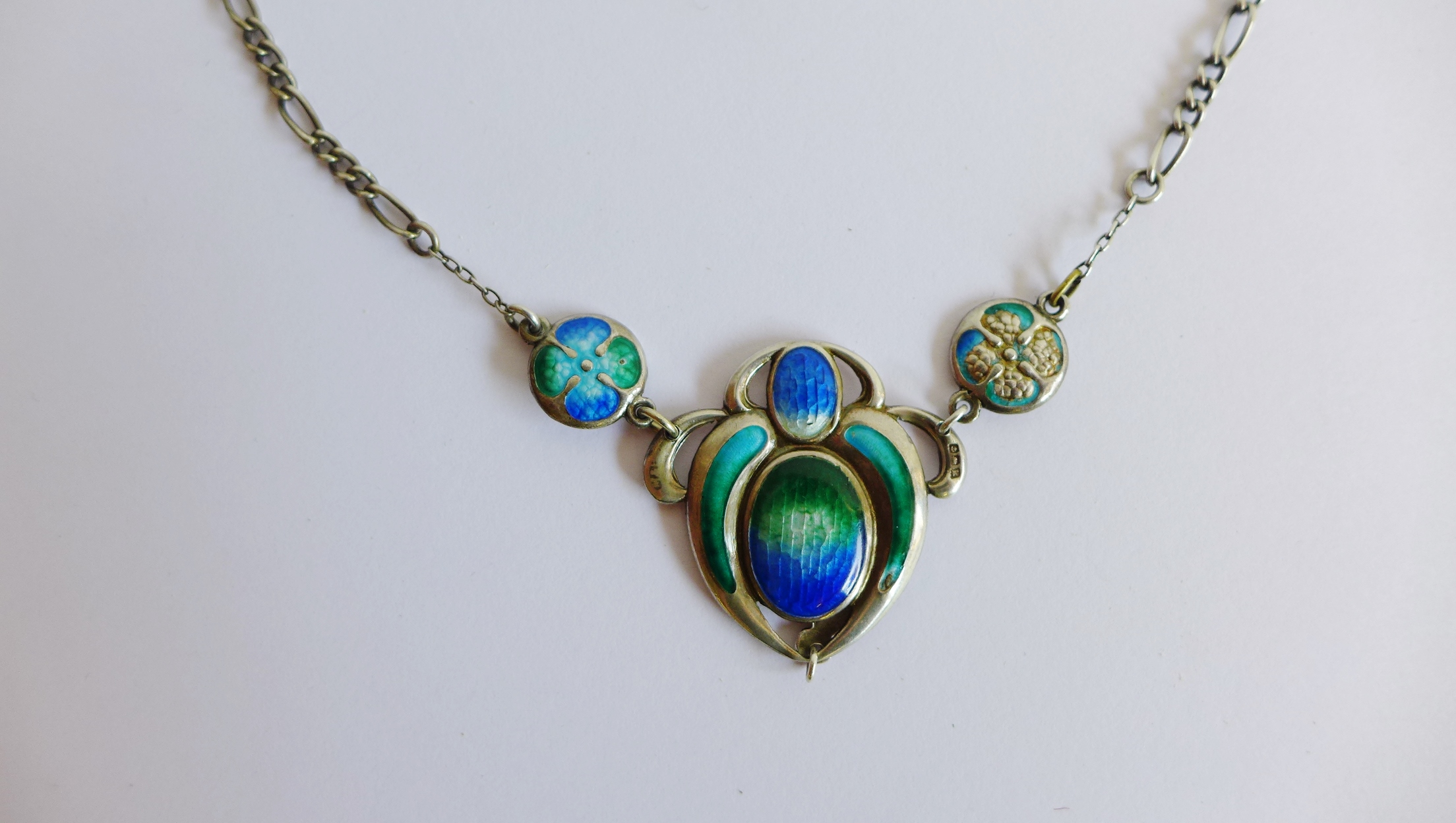 Art Nouveau style blue and green enamel and white metal pendant on a fancy silver link chain