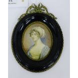 Oval painted portrait miniature on ivorine panel of a young woman dressed in white and blue dress