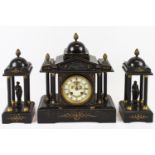 A black slate mantel clock with gilt decoration, the clock face flanked by three pillars