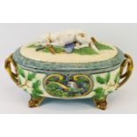 A Minton 'Hunting Dog' majolica tureen of basket form, the sides moulded with cartouche of game