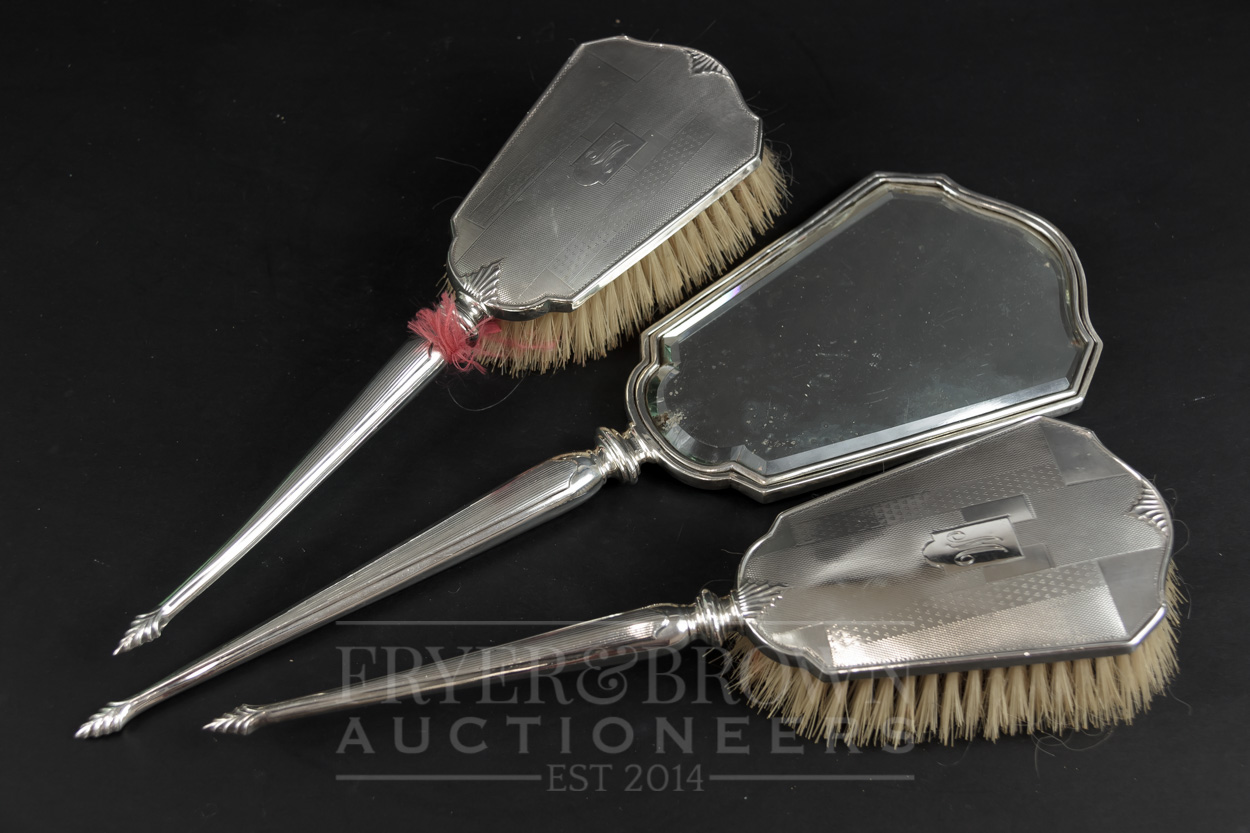 A three piece Art Deco dressing table set, comprising two brushes and a hand mirror, makers mark for - Image 2 of 2